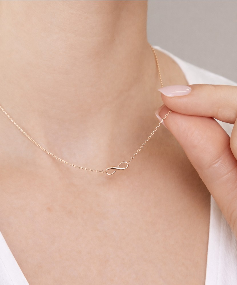 Kultainen kaulakoru riipuksella "ääretön"