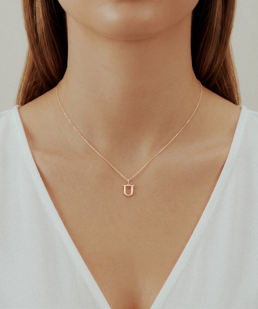 Gold pendant with diamond letter U