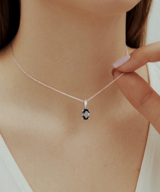 White gold pendant with diamonds and London topaz