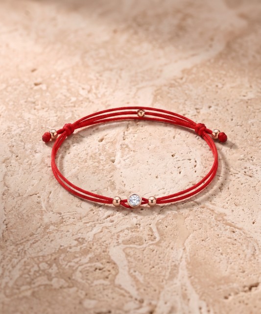 Red string bracelet with gold zirconia pendant