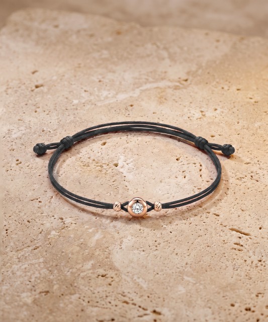 Black string bracelet with gold zirconia pendant