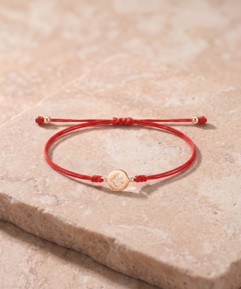 Red string bracelet with gold pendant