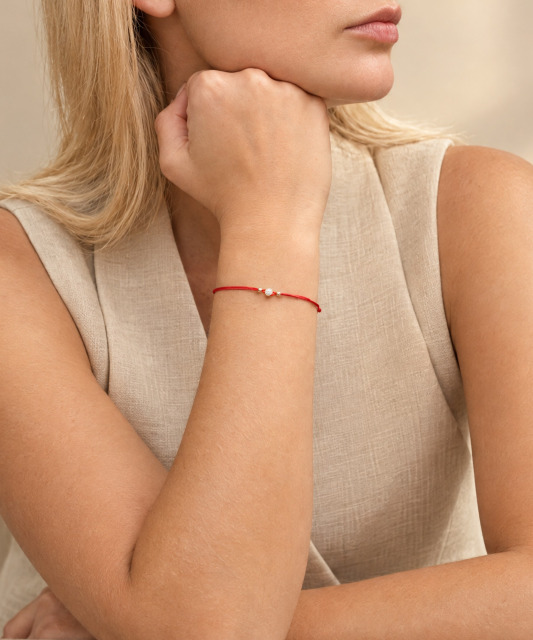 Red string bracelet with gold zirconia pendant