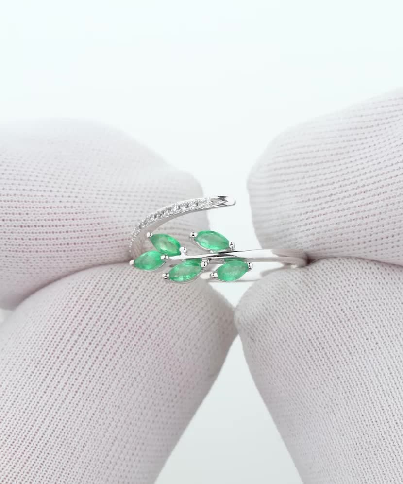 White gold ring with diamonds and emeralds