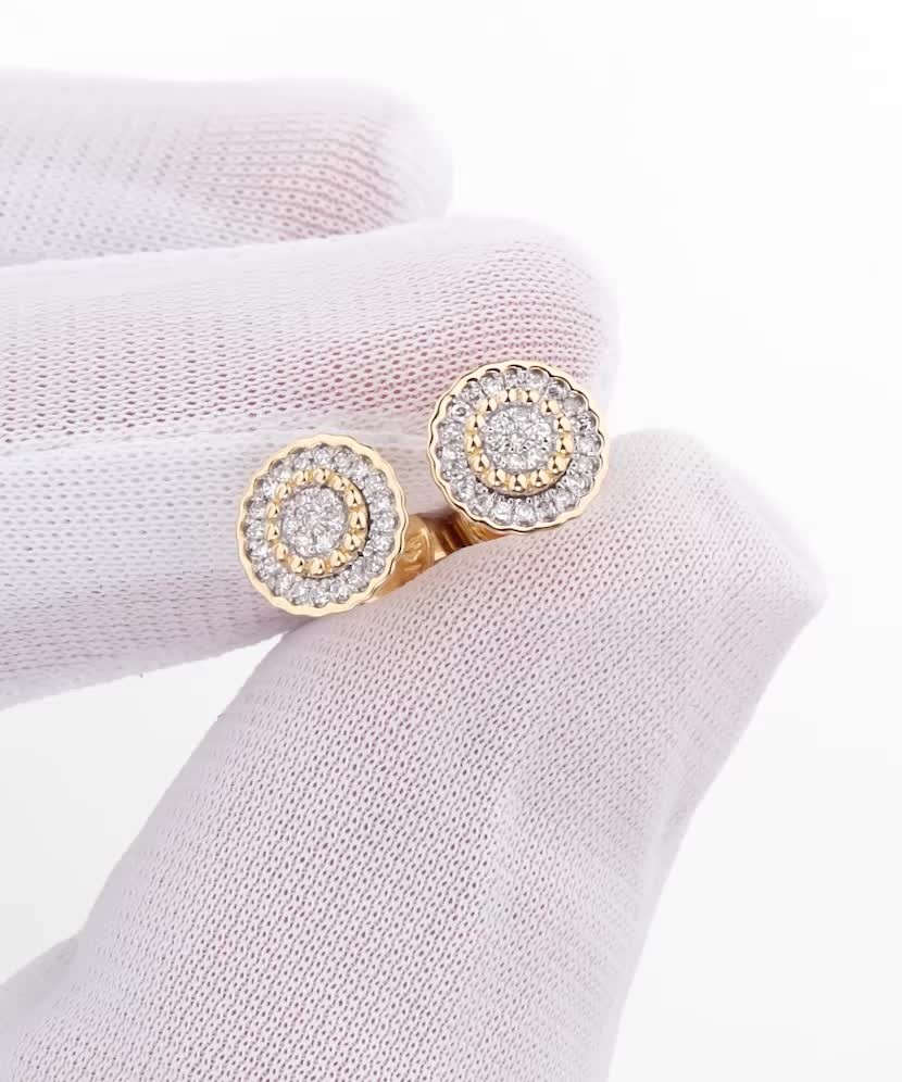 Keltaiset kultaiset korvakorut timanteilla