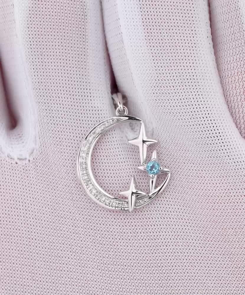 Valkokultainen riipus timanteilla ja topaasilla