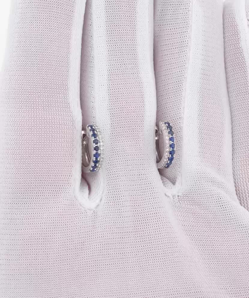 Valkokultaiset korvakorut safiireilla ja timantteja