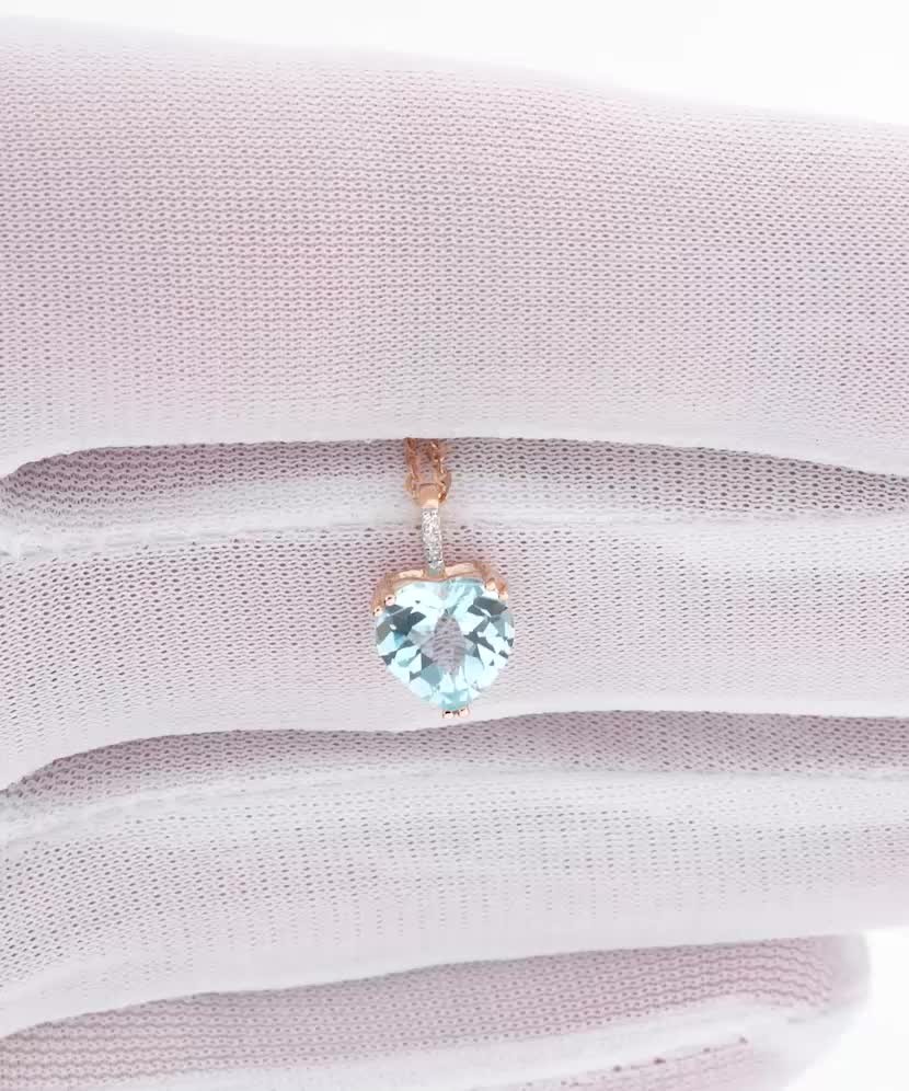 Gold pendant with topaz and zircons