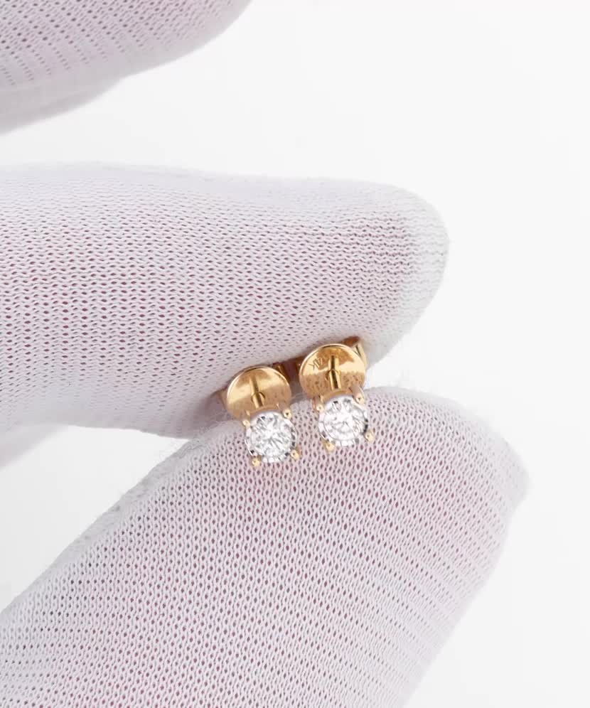 Keltaiset kultaiset korvakorut timanteilla