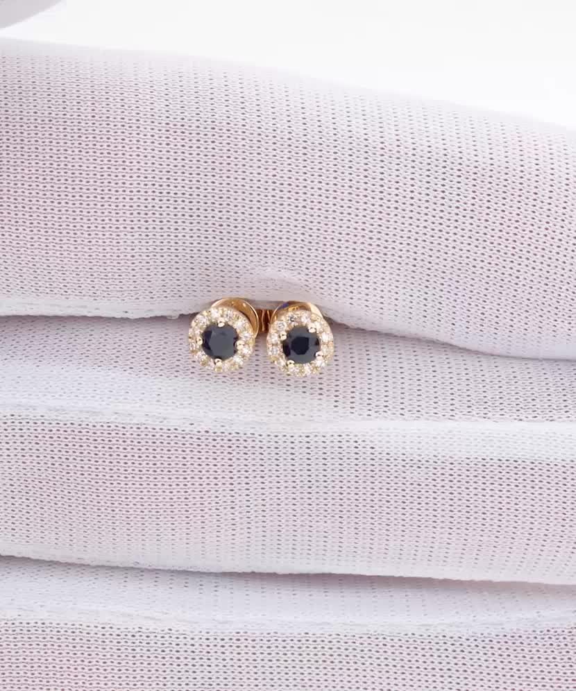 Keltakultaiset korvakorut safiireilla ja timanteilla