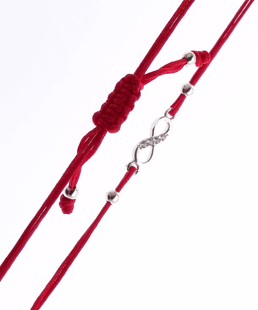 Red string bracelet with a silver pendant "Infinity"