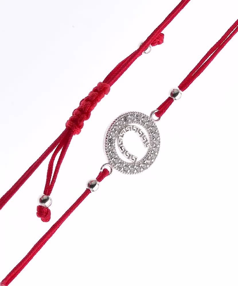 Red string bracelet with a silver pendant "horseshoe"