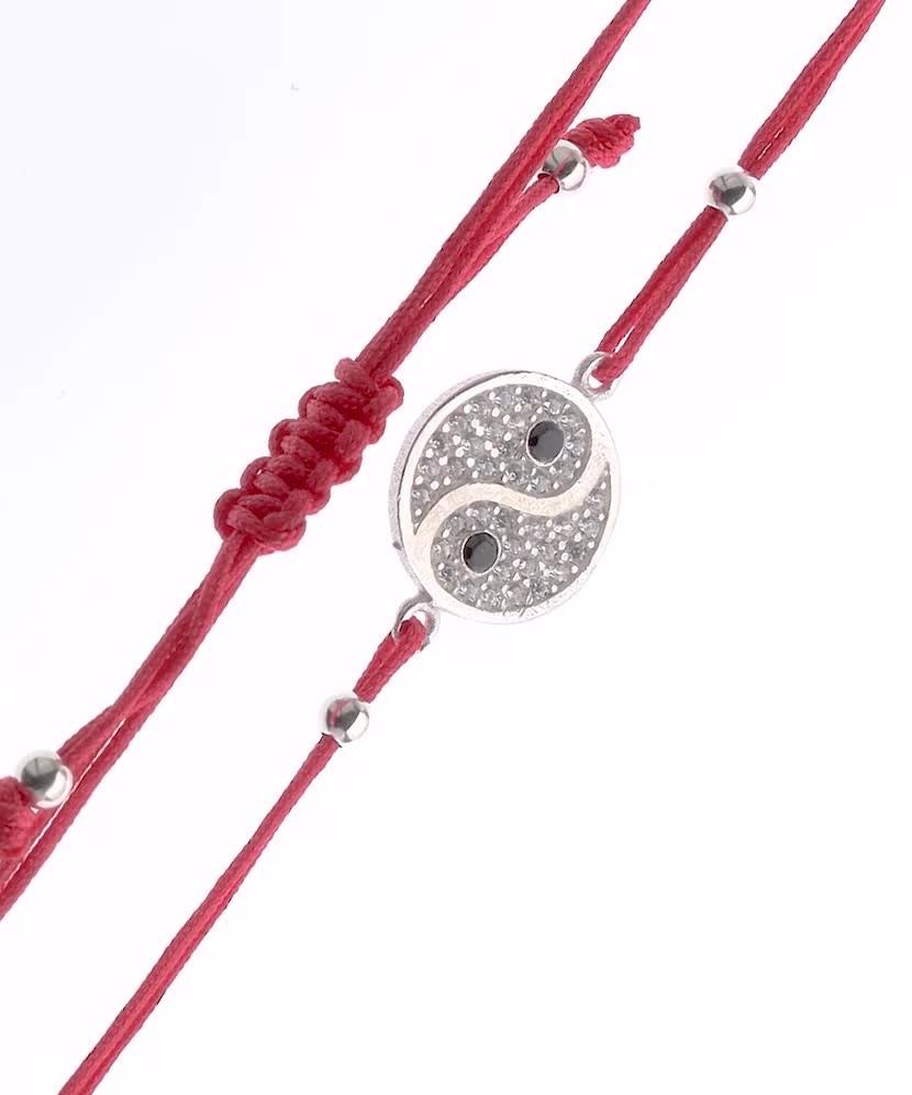 Red string bracelet with a silver pendant with zirconium