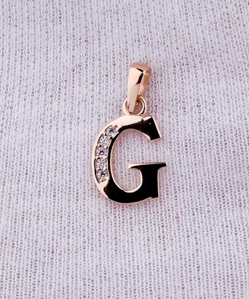 Gold pendant with zircons Letter G