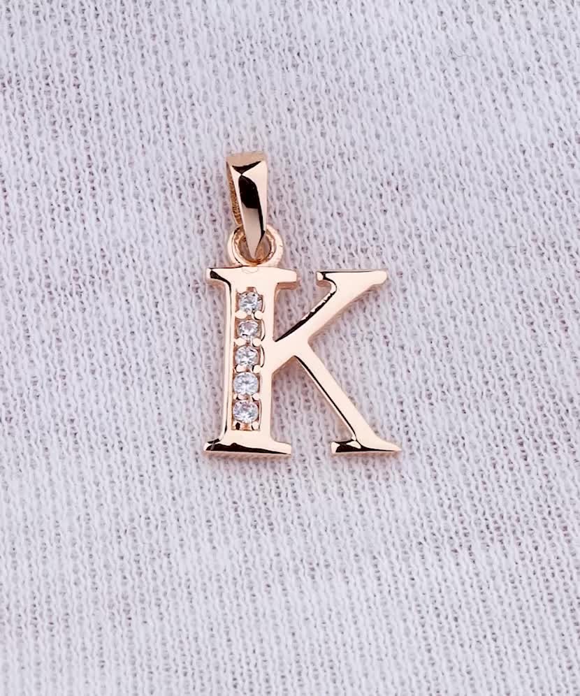 Gold pendant with zircons Letter K