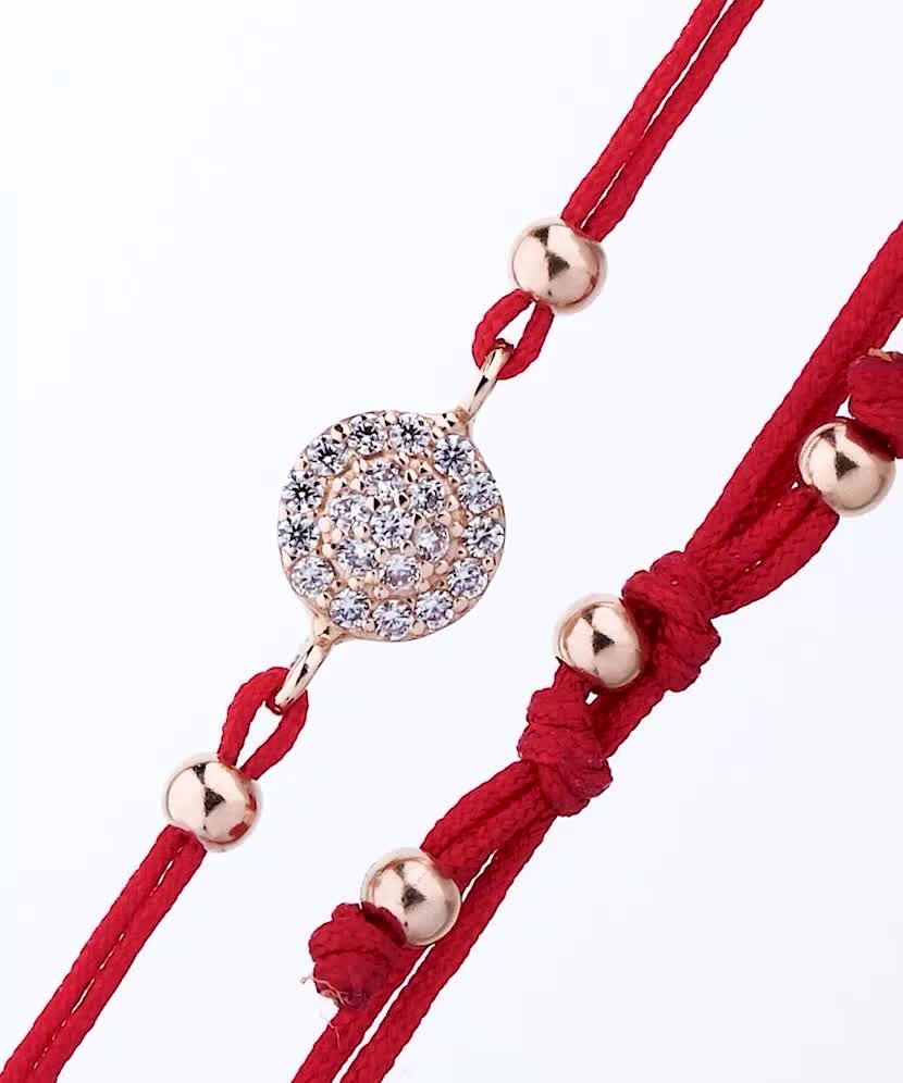 Red string bracelet with a gold pendant and zirconium