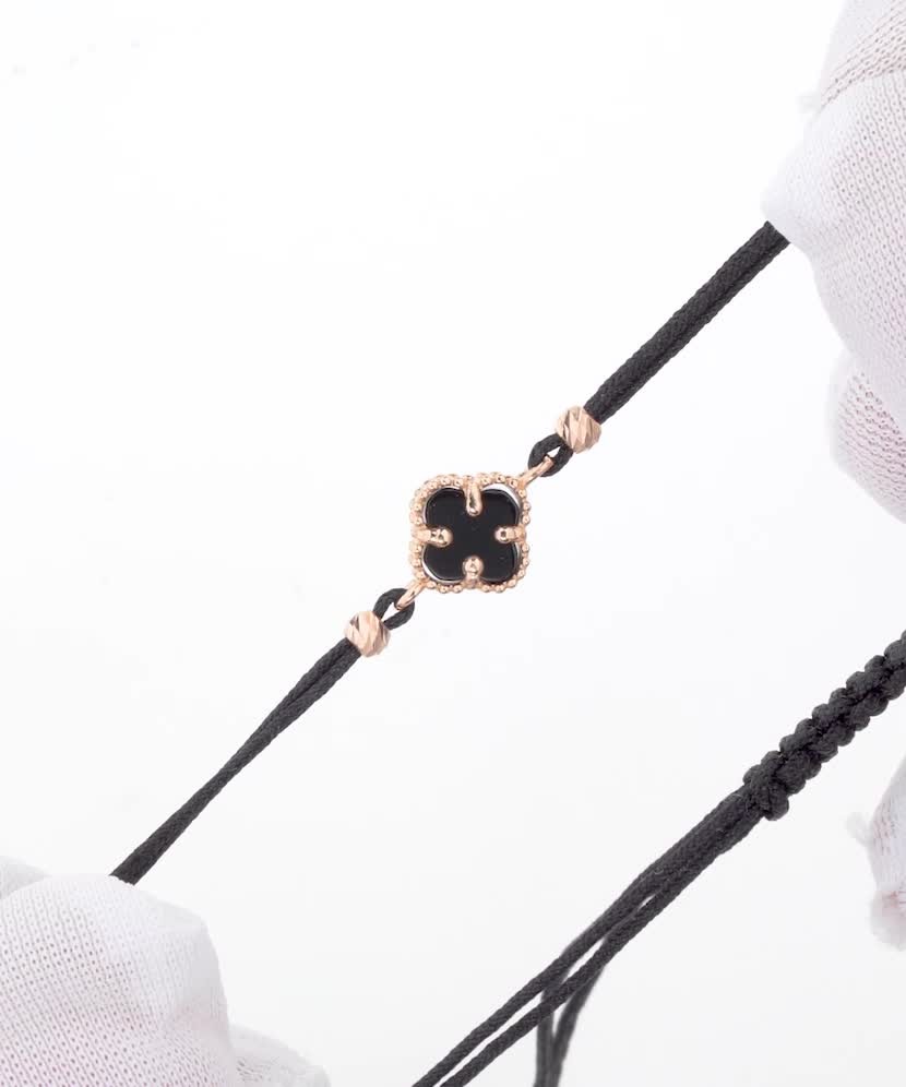 Black string bracelet with gold and onix