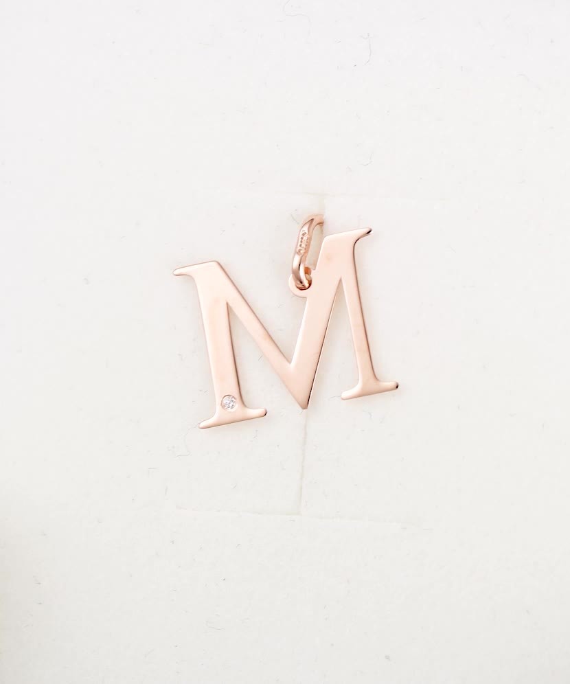 Gold pendant with diamond letter M