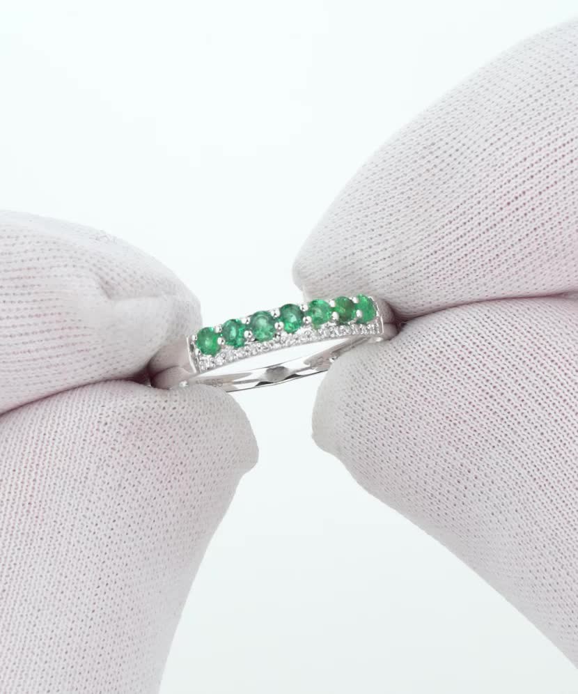 White gold ring with diamonds and emeralds
